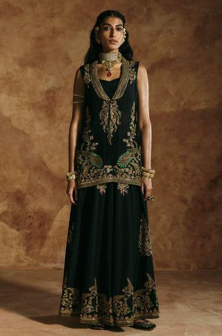 Front view of the black jacket sharara set with the gold embroidered open-front jacket by Aman Takyar at Mrs. G