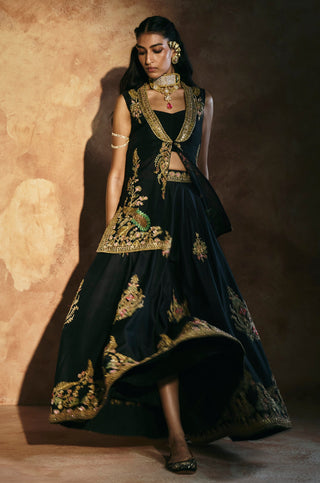 Walking view of the black sharara with the jacket worn open and a gold hem by Aman Takyar at Mrs. G