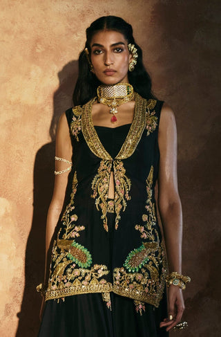 Front walking view of the black jacket sharara set with gold motifs on the sharara by Aman Takyar at Mrs. G