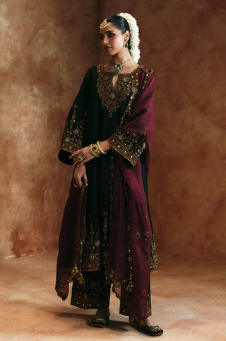 Side-facing full-length view of the black keyhole kurta set with embroidered sleeve bands by Aman Takyar at Mrs. G