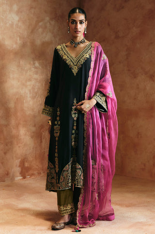 Front view of the black v-neck kurta set with the pink organza dupatta draped over one shoulder by Aman Takyar at Mrs. G