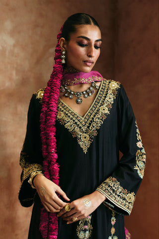 Waist-up view of the black v-neck kurta set showing the gold-embroidered V neckline and cuffs by Aman Takyar at Mrs. G