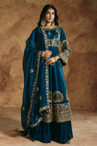Front view of the teal blue anarkali set with the embroidered organza dupatta draped by Aman Takyar at Mrs. G