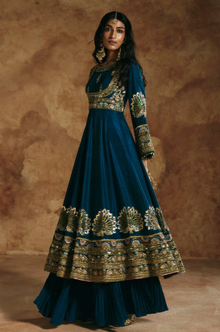 Three-quarter view of the teal blue anarkali showing the flared layer beneath by Aman Takyar at Mrs. G