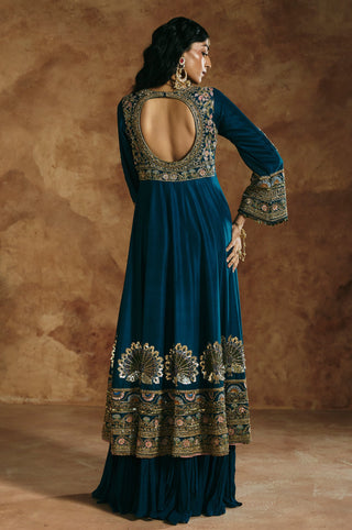 Back view of the teal blue anarkali with a rounded cut-out back and peacock hem by Aman Takyar at Mrs. G