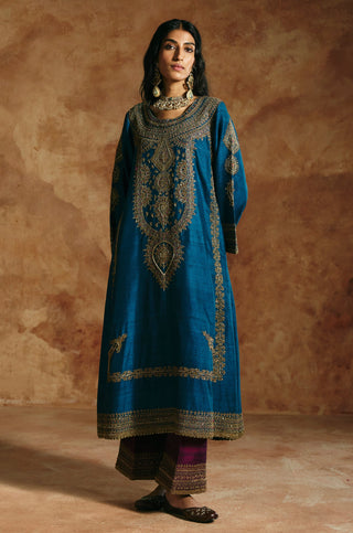 Full-length front view of the teal blue kurta set with plum pants and an embroidered hem by Aman Takyar at Mrs. G