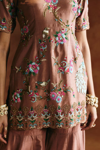 Close-up of the bronze sharara set kurta with floral thread embroidery, a bird and a peacock by Aman Takyar at Mrs. G