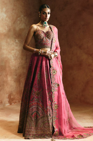 Full-length front view of the carrot pink lehenga set with sweetheart blouse and trailing organza dupatta by Aman Takyar at Mrs. G