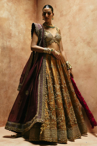 Full-length front view of the copper gold lehenga set with wine dupatta and gold-embroidered blouse by Aman Takyar at Mrs. G