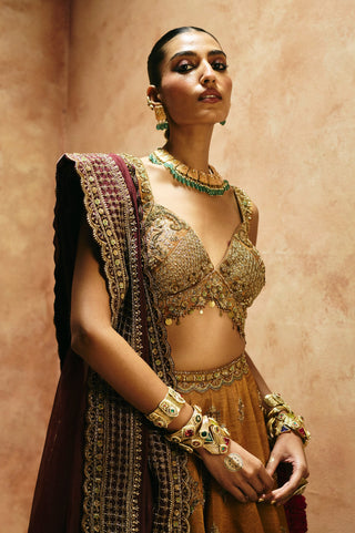 Waist-up view of the copper gold blouse's deep V-neck embroidery and the wine dupatta's scalloped border by Aman Takyar at Mrs. G