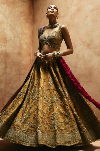 Twirling view of the copper gold lehenga showing the full flare and wide embroidered hem by Aman Takyar at Mrs. G