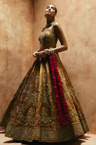 Full-length view of the flared copper gold lehenga with branching zardozi embroidery by Aman Takyar at Mrs. G