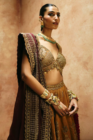 Waist-up close-up of the copper gold blouse with coin drops and the wine dupatta border by Aman Takyar at Mrs. G
