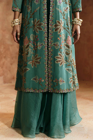 Close-up of the coral blue jacket's embroidered hem and the sheer layered skirt by Aman Takyar at Mrs. G