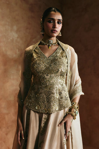 Waist-up view of the gold peplum top with V-neckline and dense zardozi embroidery by Aman Takyar at Mrs. G