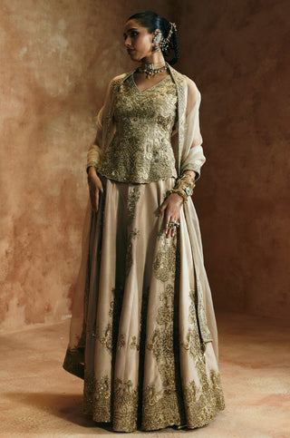 Side view of the gold sharara set with the sheer organza dupatta falling from the shoulders by Aman Takyar at Mrs. G