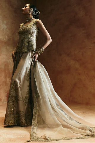 Side view of the gold sharara set with the scalloped dupatta border trailing along the floor by Aman Takyar at Mrs. G