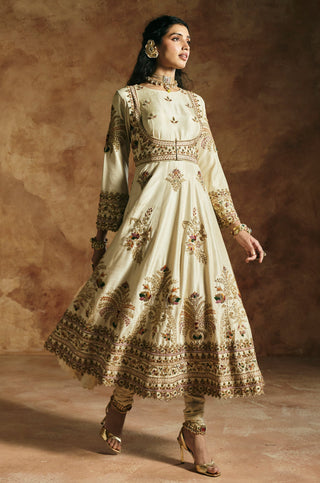 Side view of the ivory anarkali flared skirt with the deep embroidered hem by Aman Takyar at Mrs. G