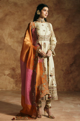 Front view of the ivory anarkali with the color-blocked orange and pink dupatta by Aman Takyar at Mrs. G