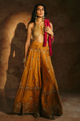 Full-length view of the mustard sharara's vertical zardozi motifs and deep embroidered hem band by Aman Takyar at Mrs. G
