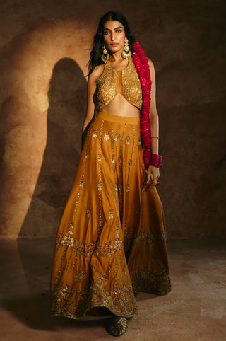 Front view of the mustard halter top and sharara in low light, showing the embroidered hem by Aman Takyar at Mrs. G