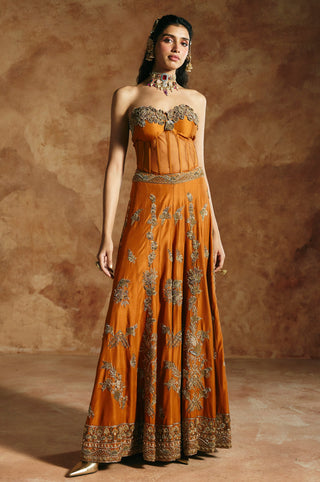 Full-length front view of the orange corset and sharara set with embroidered sweetheart edge by Aman Takyar at Mrs. G