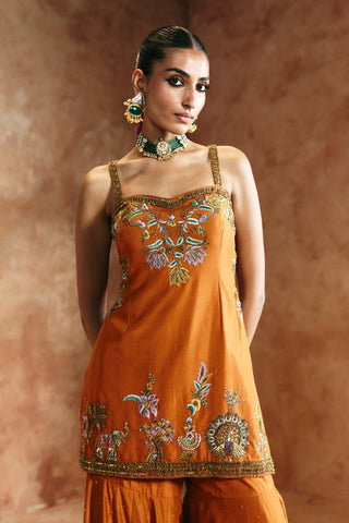 Waist-up view of the orange sharara set showing the camisole kurta with floral and peacock embroidery by Aman Takyar at Mrs. G
