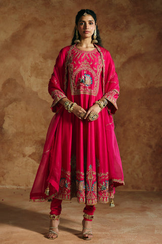 Front view of the fuchsia pink anarkali set with the organza dupatta draped over the arms by Aman Takyar at Mrs. G