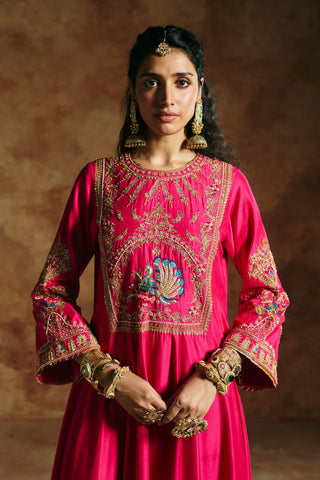 Close-up of the fuchsia pink anarkali's square yoke with a blue and green peacock by Aman Takyar at Mrs. G