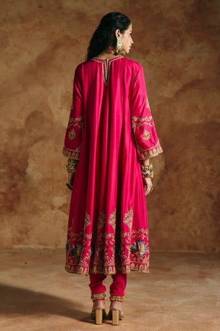 Back view of the fuchsia pink anarkali with embroidered sleeves and hem band over the churidar by Aman Takyar at Mrs. G