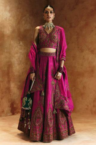 Full-length front view of the rani pink lehenga set with embroidered V-neck blouse and organza dupatta by Aman Takyar at Mrs. G