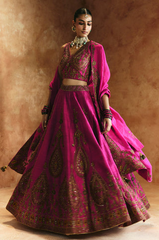 Twirling view of the rani pink lehenga showing paisley panels and the embroidered hem by Aman Takyar at Mrs. G