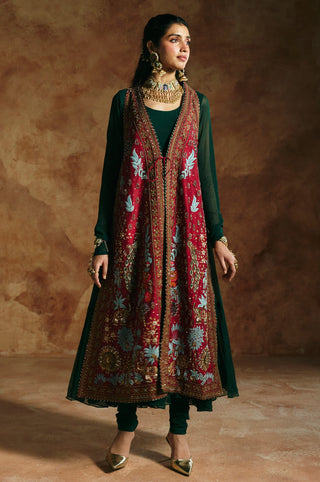 Full-length three-quarter view of the red jacket and green anarkali with sheer sleeves by Aman Takyar at Mrs. G