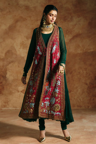 Walking view of the red jacket over the flared green anarkali by Aman Takyar at Mrs. G