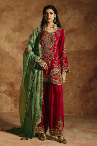 Front view of the red kurta pants set with the sea-green organza dupatta draped over the arms by Aman Takyar at Mrs. G