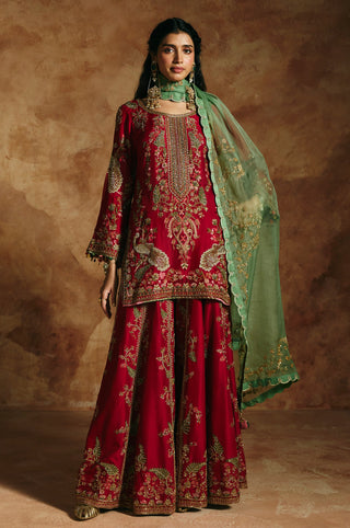 Front view of the red sharara set with gold-embroidered kurta and sea-green organza dupatta by Aman Takyar at Mrs. G