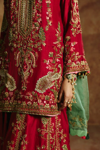 Close-up of the red kurta's gold zardozi neck panel and peacock motifs by Aman Takyar at Mrs. G