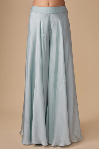 Close-up of the plain wide-flare baby blue satin sharara on a flat waistband by Asaga at Mrs. G