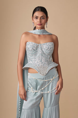 Waist-up view of the sweetheart corset covered in mirrors, pearls and sequins with pearl strands at the sharara waist by Asaga at Mrs. G