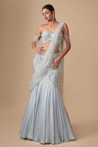 Full-length front view of the baby blue fish-cut pre-draped saree with crystal drop pallu and off-shoulder blouse by Asaga at Mrs. G