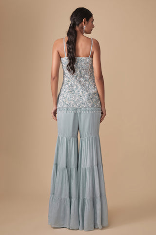 Full-length back view of the baby blue strappy kurti and the three-tier gathered sharara by Asaga at Mrs. G