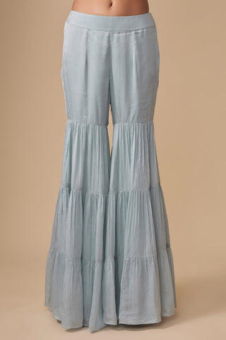 Close-up of the three-tier gathered baby blue sharara on a plain waistband by Asaga at Mrs. G