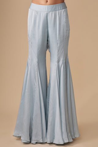 Close-up of the plain baby blue satin sharara cut in wide flared gores by Asaga at Mrs. G