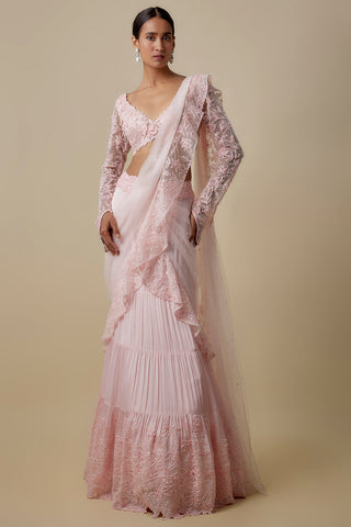 Full-length front view of the baby pink pre-draped saree with a floral net blouse and a tiered lace hem by Asaga at Mrs. G