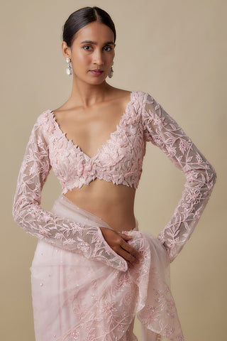 Waist-up view of the baby pink floral appliqué net blouse with a scalloped V neckline and net drape by Asaga at Mrs. G