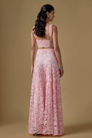 Back view of the baby pink scooped corset back above the floral appliqué sharara by Asaga at Mrs. G