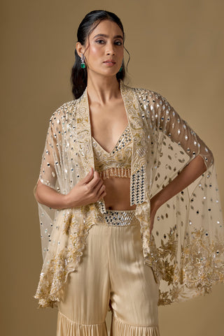 Waist-up close-up of the beige mirror work bralette and the open cape with gold floral embroidery by Asaga at Mrs. G