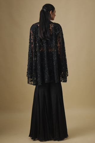 Back view of the black floral appliqué net cape over the satin sharara by Asaga at Mrs. G