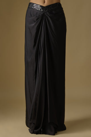 Close-up of the black draped satin skirt with a front knot and mirror waistband by Asaga at Mrs. G