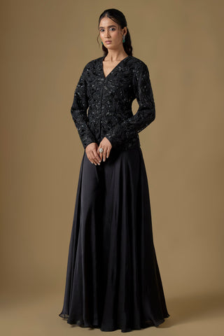 Full-length front view of the black sequin paisley jacket over a wide flared satin organza sharara by Asaga at Mrs. G